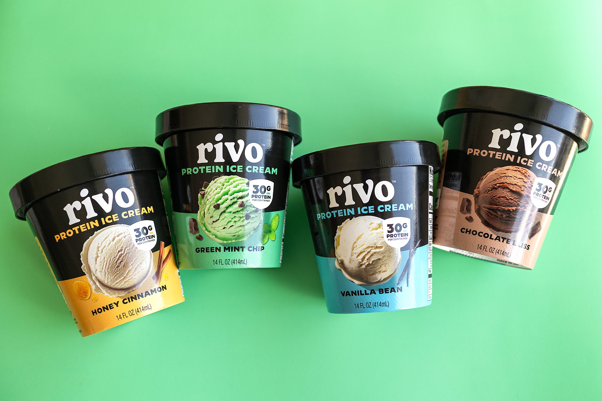 Four containers of Rivo protein ice cream on a green background